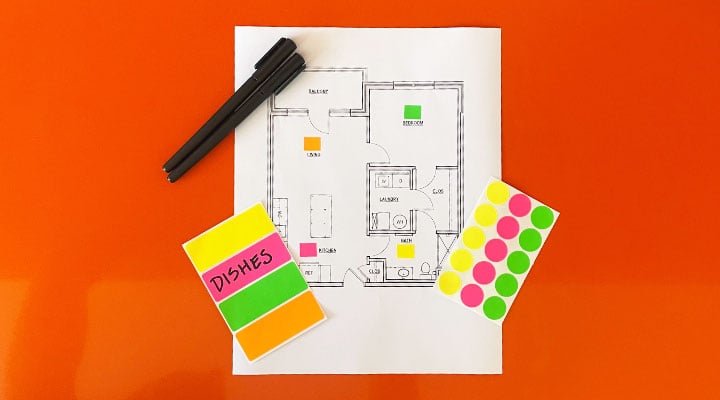 view of color coded house floor plan and color coded sticker on a orange counter